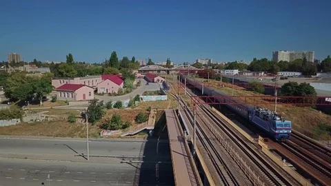 Aerial view of a train pass on the background of a railway in an industrial Stock Footage 80870264