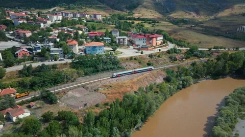 Aerial view of train passing rural village 스톡 동영상 332498769