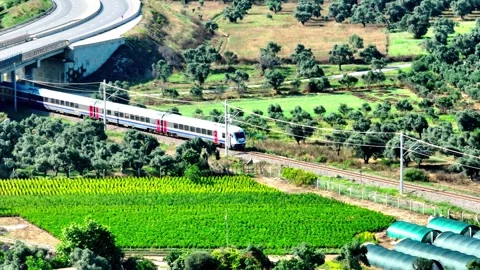 Aerial view of train passing through farmland Stock Footage 244744360