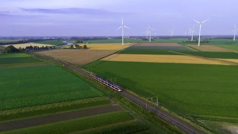 Aerial View of a Train Passing Through a Typical Dutch Landscape with Windmills Stock-Footage 282302371