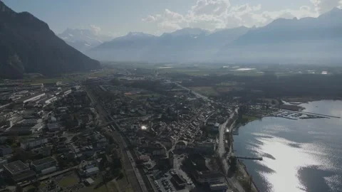 Aerial View of Train Passing Through Villeneuve with Road Traffic 動画素材 330119712