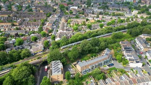 Aerial view of a train passing through Peckham, United Kingdom. Stock Footage 340781103