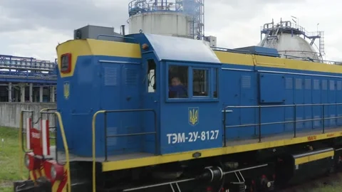 Aerial view of a train on the rails next to the production buildings, chemical Stock Footage 170146041