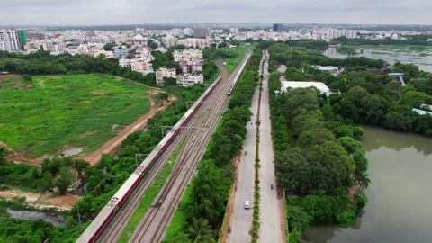 Aerial view of a train running parallel to PVNR Marg, with city view and Stock-Footage 316302414