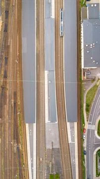 Aerial view of a train station with multiple tracks and a train at the platform Stock Photos