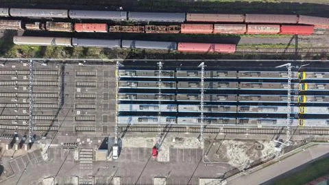 Aerial view train station with multiple tracks and parking lot Stock Photos
