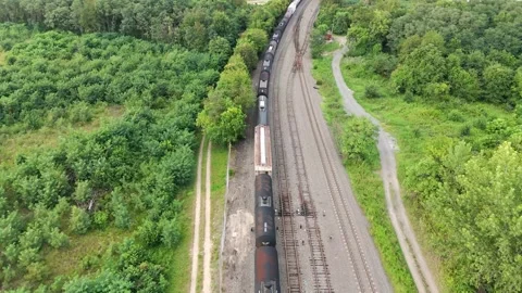 Aerial View of Train Traveling Down the Tracks Stock Footage 248948209