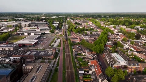 Aerial view of a train traveling through a dutch suburban town 動画素材 336594773