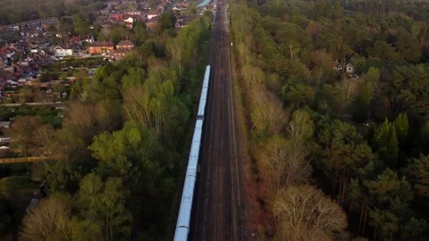 Aerial view train travelling through English countryside on sunny day Stock Footage 182501901