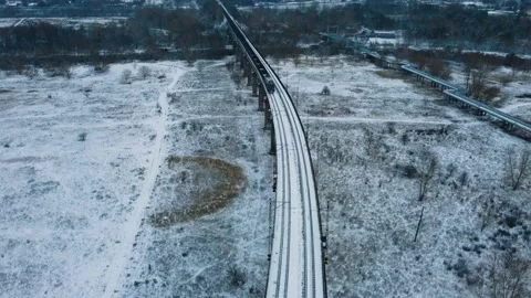 Aerial view train with wagons moving along the overpass Video stock 227399912