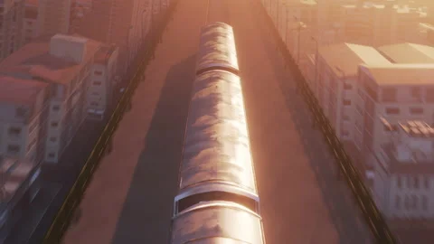 Aerial view of train in warm sunset light passing through city Stock Footage 155429130