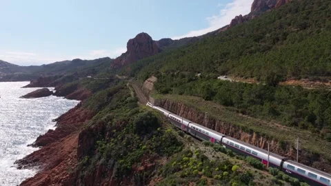 Aerial view of train winding through Massif de LEsterel by sea, France Video stock 310641187