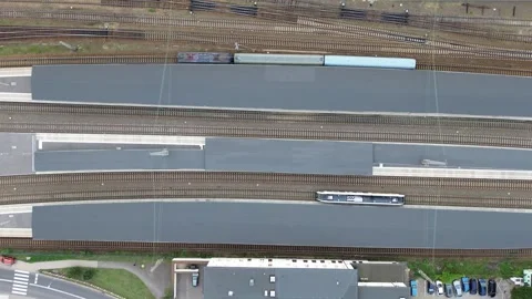 Aerial view of trains at the station during a busy afternoon in a metropolitan Stock Footage 281404404
