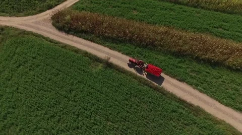 Aerial view of traktor driving through the fields Stock Footage 55318459
