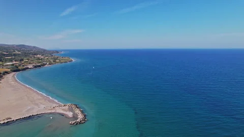 Aerial view of a tranquil beach and azure sea on a sunny day Stock Footage 290084461