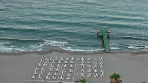 Aerial View of a Tranquil Beach with Pier Stock Footage 282930262
