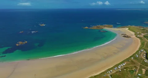 Aerial view of the tranquil beach at Plage des Amiets with clear turquoise water Video stock 311274147