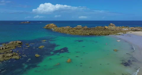 Aerial view of the tranquil beach at Plage des Amiets with clear turquoise water 스톡 동영상 311276780