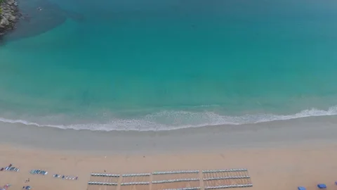 Aerial view of tranquil beach with sun loungers and gentle waves in Thailand Stockbeeldmateriaal 337417883
