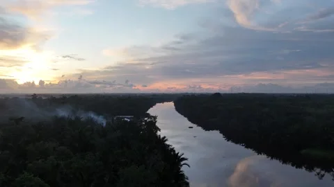 Aerial View of Tranquil Sunset Over Winding Kapuas River and Forest Stock Footage 334172159