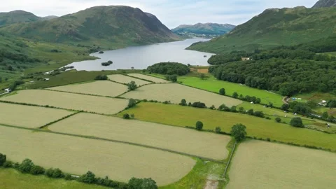 Aerial view of a tranquil valley with lush green fields Stock Footage 345523725