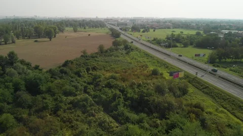Aerial view of trees and fields by the road Stock Footage 115726602