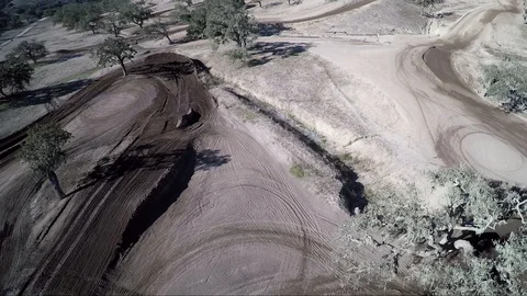 Aerial view of trees and a former desert race track in slow motion Stock Footage 92105751