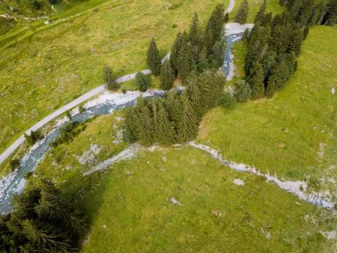 Aerial view on trees, paths and a creek used by people for refreshment in the Stock Photos
