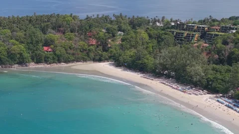 Aerial view of tropical beach with clear water and lush green surroundings Video stock 342332966