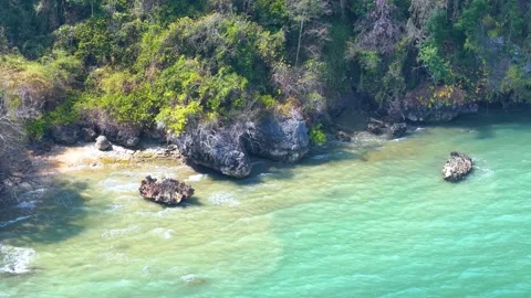 Aerial View of Tropical Limestone Cliffs and Turquoise Ocean in Thailand 動画素材 328399058