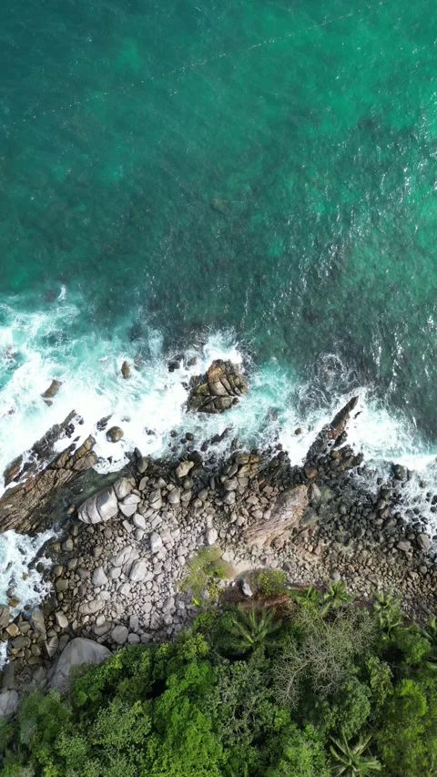 Aerial View of Tropical Ocean Waves Crashing on Rocky Shoreline in Phuket, Stock Footage 335583446