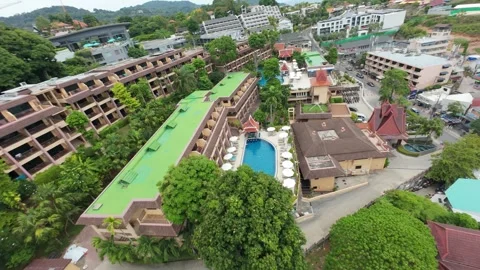 Aerial view of tropical resort with pool, buildings, and lush greenery Video stock 342333476