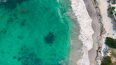 Aerial view of a tropical sandy beach on Saint Martin island in the Caribbean.  Видео 336364743