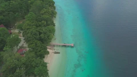 Aerial View of Tropical Sandy Beach and Wooden Pier on Turquoise Sea Coast Video stock 337102355