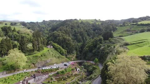 Aerial view of tropical waterfall surrounded by forest in Ribeira dos Caldeiroes Stock Footage 340165236