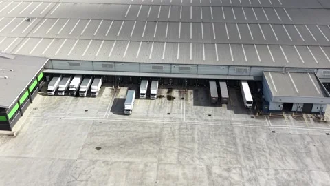 Aerial view of a truck leaving loading docks at a warehouse Video stock 341919184