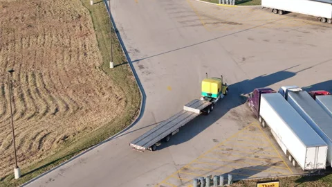 Aerial view of the truck with step deck trailer is moving on truck stop. Top Stock Footage 296912940