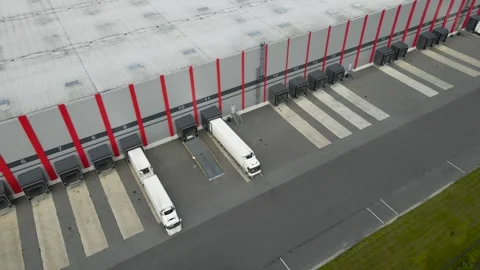 Aerial view of trucks loading at warehouse distribution center Stock Footage 343934510