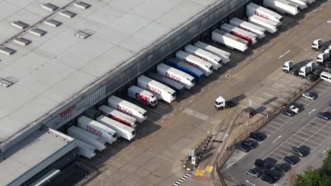 Aerial view of trucks at a logistics warehouse loading dock Stock Footage 344752099