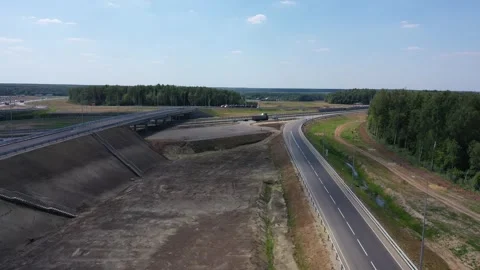 Aerial view of trucks moving through highway interchange Vidéo 321773540