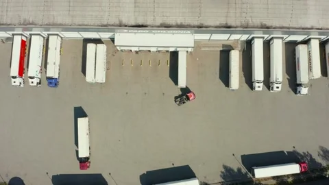 Aerial view of trucks parked at the loading dock of the warehouses. Stock Footage 248070822
