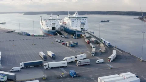Aerial view of trucks unloading from a ropax ship Finnswan by Finnlines. Stock Footage 153787593