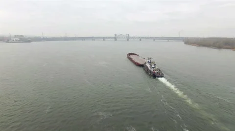Aerial view of tug boat pushing empty barge Stock Footage 58505359