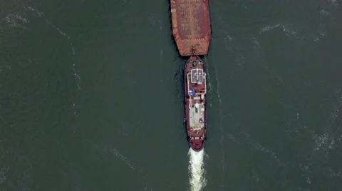 Aerial view of tug boat pushing empty barge Stock Footage 58507149