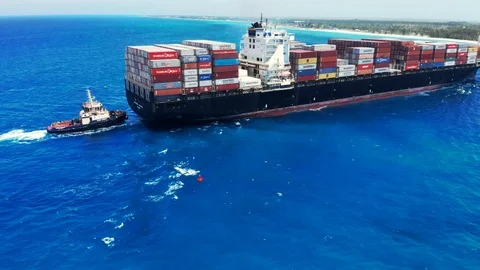 Aerial View of Tugboat and Container Cargo Ship Near Freeport Harbor, Bahamas Stock Footage 107638183