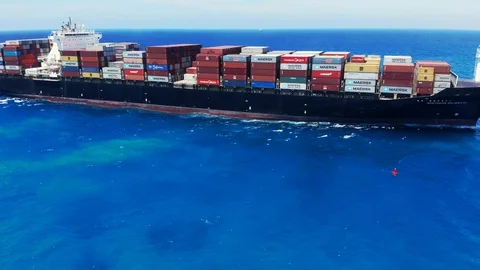 Aerial View of Tugboat and Container Cargo Ship Near Freeport Harbor, Bahamas Stock Footage 107638428