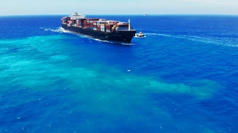 Aerial View of Tugboat and Container Cargo Ship Near Freeport Harbor, Bahamas Stock Footage 107639083
