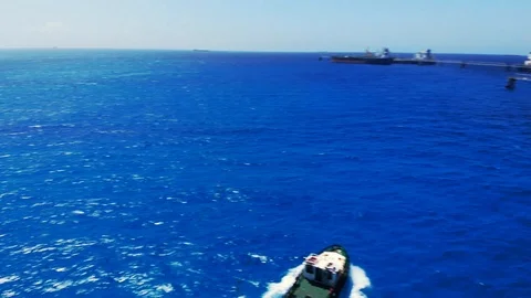Aerial View of Tugboat and Container Cargo Ship Near Freeport Harbor, Bahamas Stock Footage 107639089