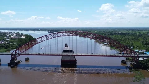 Aerial view of a tugboat pulling a barge filled with coal across the Rumpia.. Stock Footage 313095971