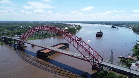 Aerial view of a tugboat pulling a barge filled with coal across the Rumpia.. Stock Footage 313096107
